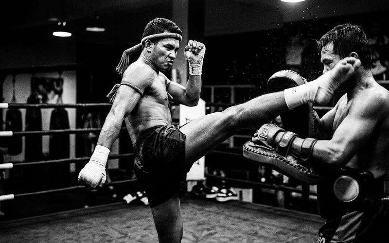 Coach holding Thai pads